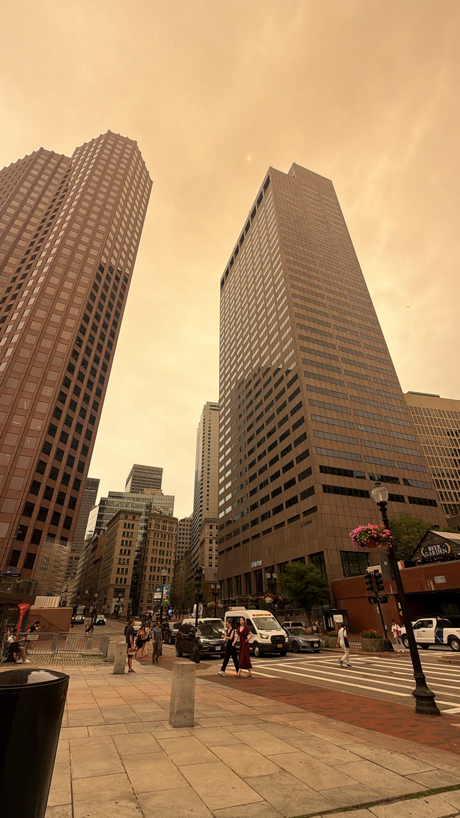 The smoke-orange sky over State Street in downtown Boston, the sun barely showing through as a faint disk.