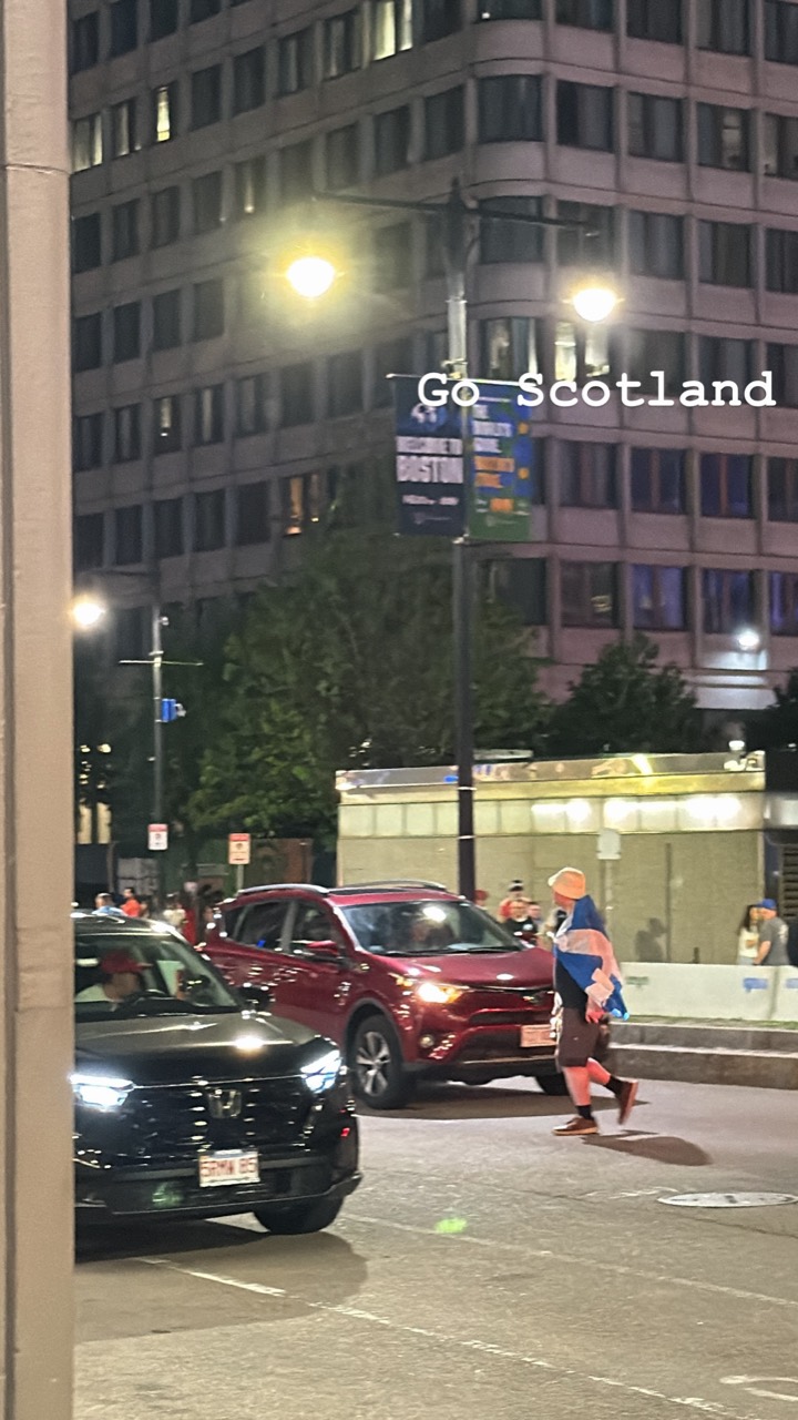 A Scotland supporter walking through Boston at night during World Cup week.